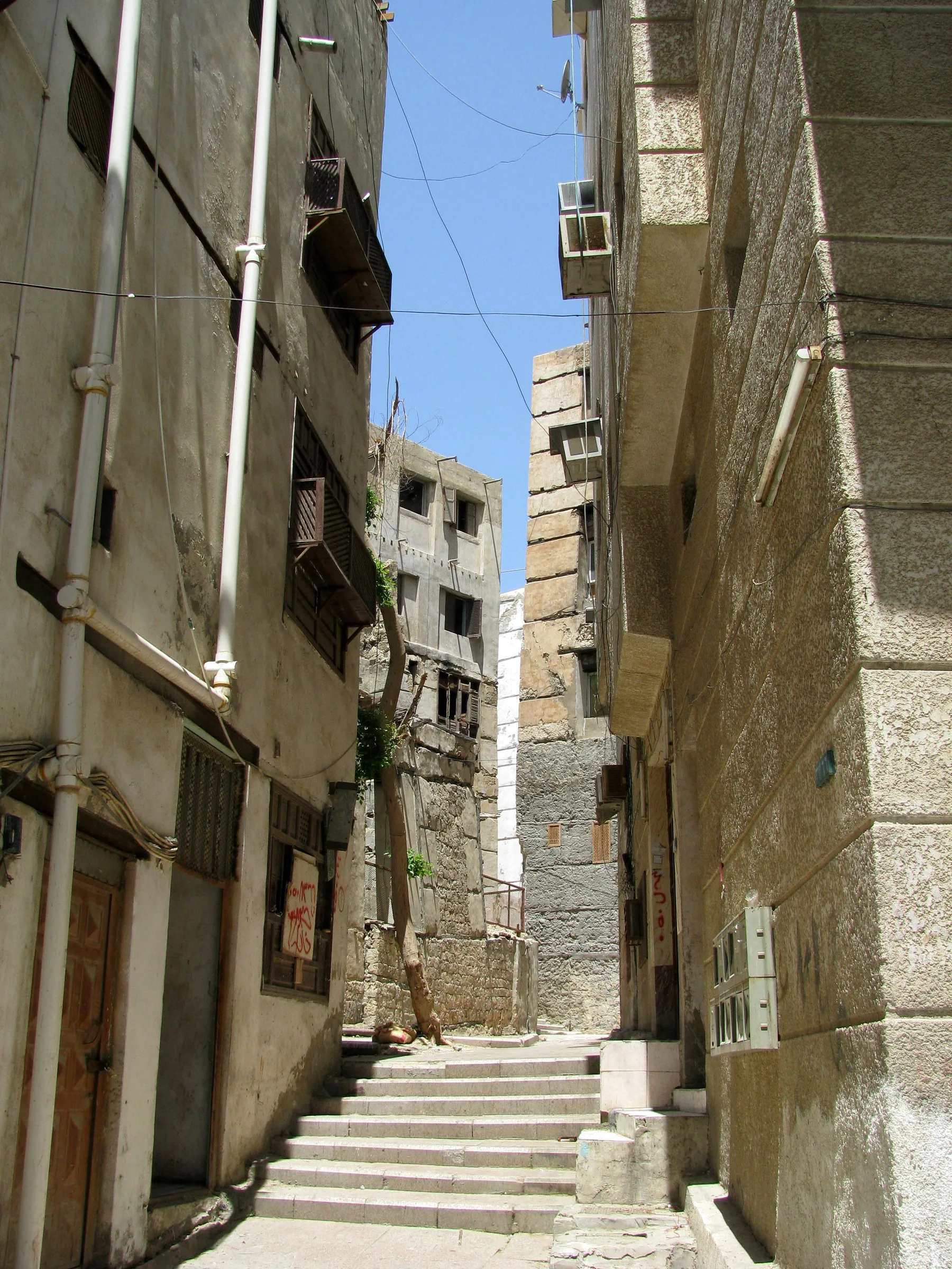 Narrow stone stairway alley between old coral-stone buildings in Jeddah's Al-Balad district
